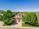 Beautiful two-story home featuring a three-car garage, well-manicured lawn, and mature trees for added privacy at 10565 Kalahari Ct, Lone Tree, CO 80124