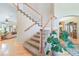 Elegant foyer featuring a staircase with wooden railings and hardwood floors leading to other rooms at 10565 Kalahari Ct, Lone Tree, CO 80124