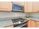 Updated kitchen features granite countertops, and modern appliances at 10565 Kalahari Ct, Lone Tree, CO 80124