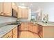 Modern kitchen with granite countertops, stainless steel appliances, and light wood cabinetry at 10565 Kalahari Ct, Lone Tree, CO 80124