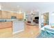Open kitchen and dining area leading to a living room with fireplace and hardwood floors at 10565 Kalahari Ct, Lone Tree, CO 80124