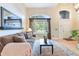 Bright living room featuring large windows, hardwood floors, and a comfortable seating arrangement at 10565 Kalahari Ct, Lone Tree, CO 80124
