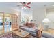 Comfortable living room with hardwood floors, a ceiling fan, and a view into the kitchen at 10565 Kalahari Ct, Lone Tree, CO 80124