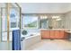 Luxurious Primary bathroom with a large soaking tub, tile floors, and walk-in shower at 10565 Kalahari Ct, Lone Tree, CO 80124