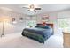 Cozy main bedroom with neutral walls and ceiling fan at 10565 Kalahari Ct, Lone Tree, CO 80124