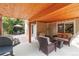 The covered patio offers a cozy outdoor space with comfortable seating, a grill, and a view of the backyard at 10565 Kalahari Ct, Lone Tree, CO 80124