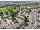 Aerial view showcasing the community's golf course, tennis courts, buildings, and parking lots at 2840 S Heather Gardens Way # A, Aurora, CO 80014
