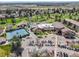 Overhead view of property featuring tennis courts, golf course, ample parking, and beautiful landscaping at 2840 S Heather Gardens Way # A, Aurora, CO 80014