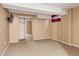 Finished basement space with carpet flooring, closet with mirrored doors, and neutral paint at 2840 S Heather Gardens Way # A, Aurora, CO 80014