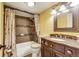 Bathroom featuring bathtub with shower, tile, vanity with a marble counter top and sink at 2840 S Heather Gardens Way # A, Aurora, CO 80014