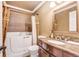 Bathroom featuring bathtub with shower, decorative curtains, vanity with a marble counter top and sink at 2840 S Heather Gardens Way # A, Aurora, CO 80014