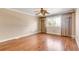 Bright bedroom with hardwood floors, neutral walls, and a large window for natural light at 2840 S Heather Gardens Way # A, Aurora, CO 80014