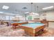 Billiard room featuring multiple tables with decorative lighting above creating a warm, inviting atmosphere at 2840 S Heather Gardens Way # A, Aurora, CO 80014