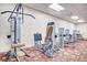 This gym area features several weight machines and exercise equipment on a patterned carpet at 2840 S Heather Gardens Way # A, Aurora, CO 80014