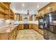 Well-appointed kitchen features custom cabinetry, tile backsplash, and modern appliances at 2840 S Heather Gardens Way # A, Aurora, CO 80014