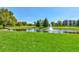Enjoy a beautiful pond featuring a fountain, grassy area, and mature trees at 2840 S Heather Gardens Way # A, Aurora, CO 80014