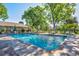 Outdoor pool area with lounge chairs and lush greenery, perfect for relaxation and recreation at 2840 S Heather Gardens Way # A, Aurora, CO 80014