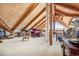 Finished attic featuring custom woodwork, a large open space, and plenty of storage at 4880 Tall Horse Trl, Sedalia, CO 80135