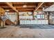 Spacious barn with concrete floor, cabinets, and stairs at 4880 Tall Horse Trl, Sedalia, CO 80135