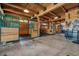 Spacious barn with concrete floor and horse stalls at 4880 Tall Horse Trl, Sedalia, CO 80135