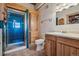 Full bathroom with shower, vanity, and wooden cabinets at 4880 Tall Horse Trl, Sedalia, CO 80135