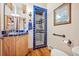 Cozy bathroom with blue tiling, hardwood floors, and a glass shower at 4880 Tall Horse Trl, Sedalia, CO 80135
