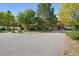 Spacious home exterior with attached garage, mature trees, and long driveway at 4880 Tall Horse Trl, Sedalia, CO 80135
