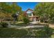 Beautiful home featuring mature trees and landscaping, a large patio, and inviting outdoor space at 4880 Tall Horse Trl, Sedalia, CO 80135
