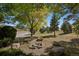 Landscaped yard featuring a built-in fire pit, perfect for outdoor gatherings and relaxation at 4880 Tall Horse Trl, Sedalia, CO 80135