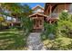 Inviting home exterior features a covered front porch, lush landscaping, and a charming walkway at 4880 Tall Horse Trl, Sedalia, CO 80135