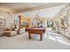 Open game room featuring a pool table, lounge seating, and a wet bar at 4880 Tall Horse Trl, Sedalia, CO 80135