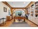 Spacious home office with custom built-in bookshelves, hardwood floors, and a large wooden desk at 4880 Tall Horse Trl, Sedalia, CO 80135