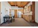 Cozy kitchenette with wooden cabinets, dining table, and chairs at 4880 Tall Horse Trl, Sedalia, CO 80135