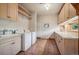 Well-appointed laundry room with a sink, washer, dryer, and plenty of cabinet space at 4880 Tall Horse Trl, Sedalia, CO 80135