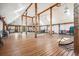 Vast living room with wooden beams, skylights, and warm wooden flooring at 4880 Tall Horse Trl, Sedalia, CO 80135
