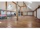 Spacious living room with wooden floors, skylights, and beautiful wood columns at 4880 Tall Horse Trl, Sedalia, CO 80135