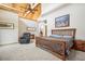 Bedroom featuring high vaulted ceilings, exposed beams, and a cozy sitting area at 4880 Tall Horse Trl, Sedalia, CO 80135