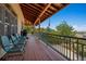Spacious covered porch with ample seating offering views of the surrounding landscape at 4880 Tall Horse Trl, Sedalia, CO 80135