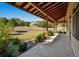 Covered patio overlooking a sprawling yard, perfect for outdoor entertaining and relaxation at 4880 Tall Horse Trl, Sedalia, CO 80135