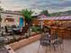 Outdoor patio with bar area featuring string lights for ambiance and a cozy dining set for entertaining guests at 109 Bear Creek Ln, Morrison, CO 80465