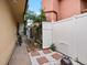 Narrow backyard showcasing a bike, grill, and stone pathway, bordered by a white fence and the house at 109 Bear Creek Ln, Morrison, CO 80465