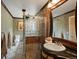 Detailed bathroom with a glass block shower, decorative tile, and wood trim at 109 Bear Creek Ln, Morrison, CO 80465