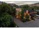 Beautiful home with a stunning rock formation backdrop and colorful lighting on a cloudy day at 109 Bear Creek Ln, Morrison, CO 80465