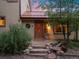 Inviting front door with stone steps, lovely wreath, and mature landscape, creating a warm welcome at 109 Bear Creek Ln, Morrison, CO 80465