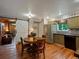 Charming kitchen with retro green cabinets and stainless steel appliances open to the living area at 109 Bear Creek Ln, Morrison, CO 80465