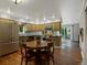 Cozy kitchen area features a wooden table and retro green cabinetry with stainless steel appliances at 109 Bear Creek Ln, Morrison, CO 80465