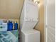 Convenient stacked washer and dryer unit in a dedicated laundry area at 109 Bear Creek Ln, Morrison, CO 80465