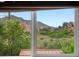 Window view showcasing scenic mountains and lush greenery at 109 Bear Creek Ln, Morrison, CO 80465