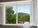 Window view showcasing scenic trees and mountains at 109 Bear Creek Ln, Morrison, CO 80465