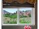 Window view showcasing scenic mountains and lush greenery at 109 Bear Creek Ln, Morrison, CO 80465